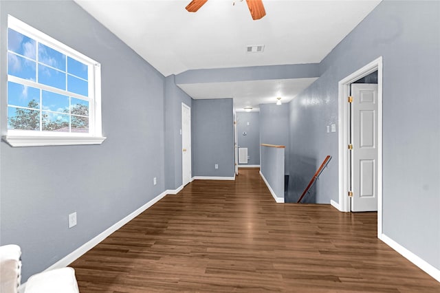 unfurnished room with dark wood-type flooring, ceiling fan, and vaulted ceiling