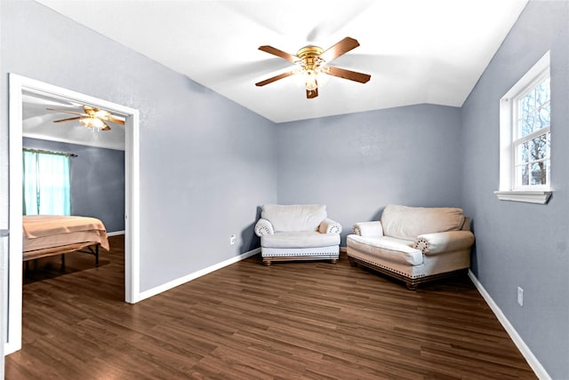 sitting room featuring dark wood-type flooring, ceiling fan, and vaulted ceiling