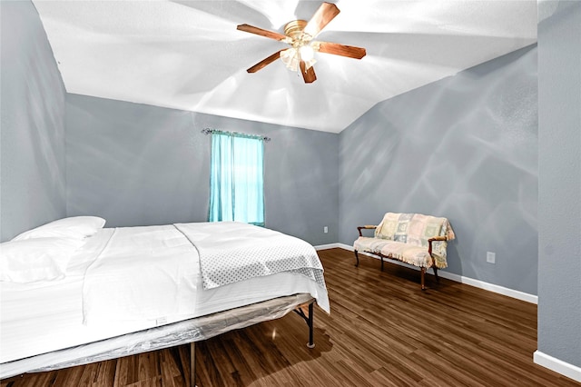 bedroom featuring hardwood / wood-style floors, vaulted ceiling, and ceiling fan