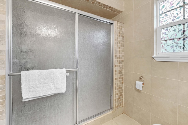 bathroom featuring a shower with door