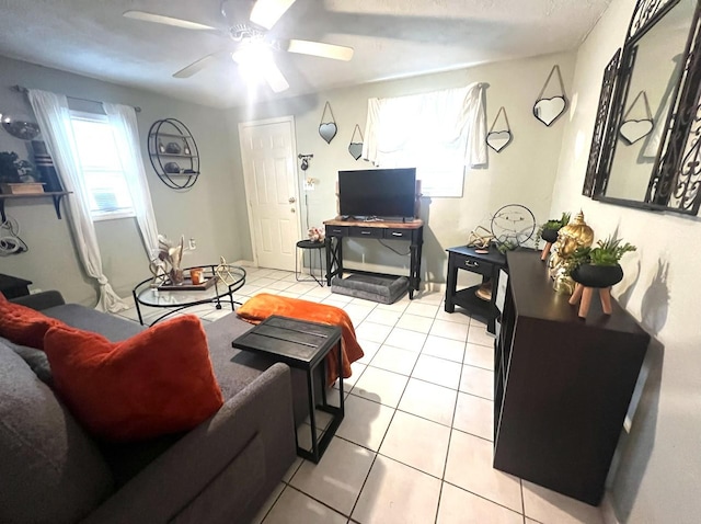 living room with ceiling fan and light tile patterned floors