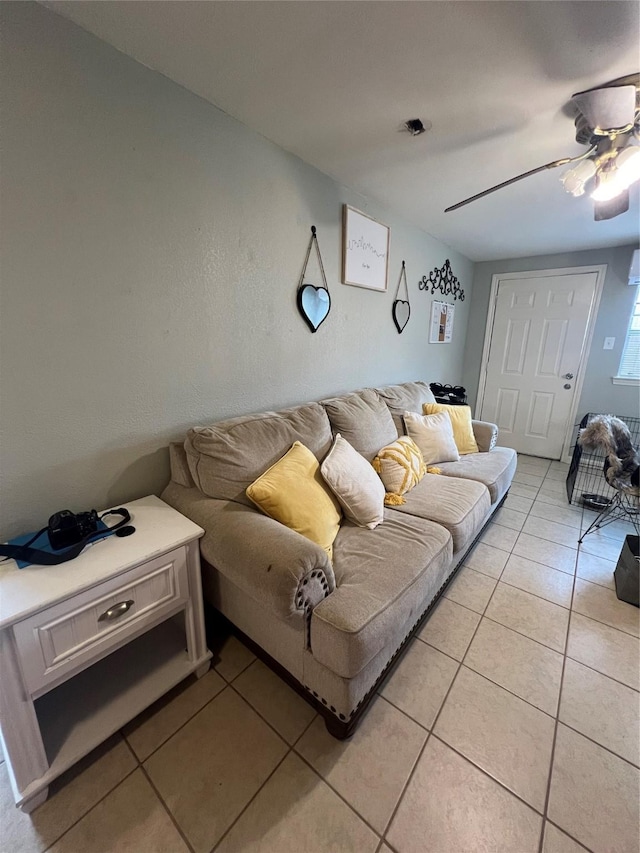 living room with ceiling fan and light tile patterned floors