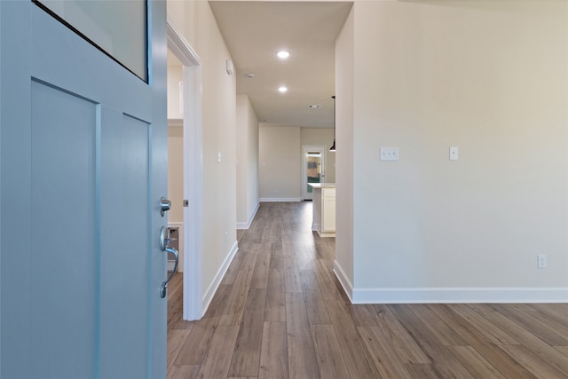 corridor with light hardwood / wood-style flooring