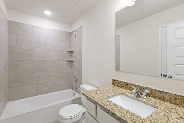 full bathroom featuring toilet, tiled shower / bath combo, and vanity