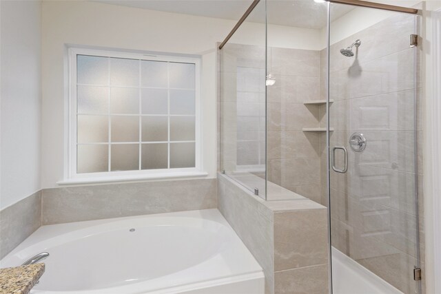 bathroom featuring shower with separate bathtub