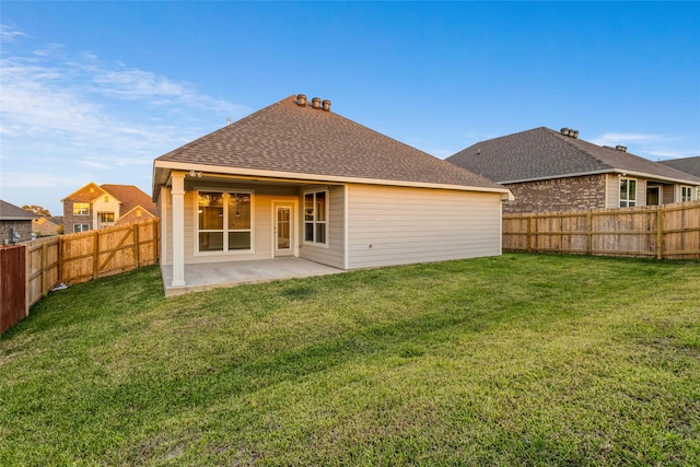 rear view of property with a patio and a lawn