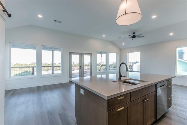 kitchen with dark hardwood / wood-style floors, a center island with sink, lofted ceiling, and sink