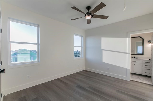 unfurnished room featuring dark hardwood / wood-style floors, plenty of natural light, and ceiling fan