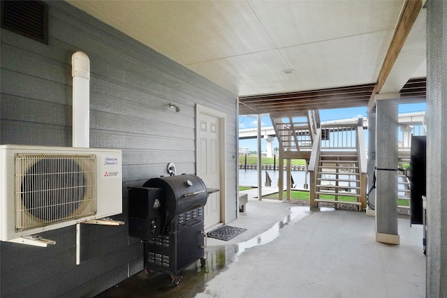 view of patio / terrace with grilling area and a water view