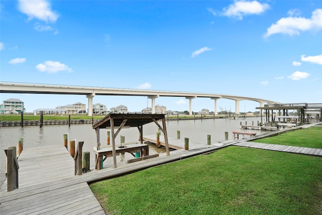 dock area featuring a water view and a yard