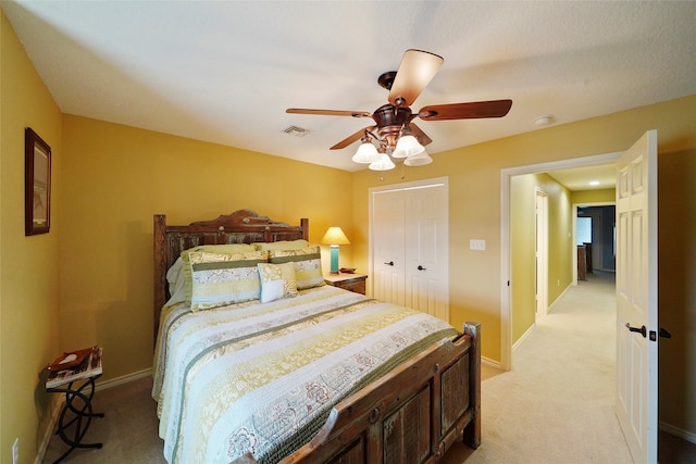 carpeted bedroom featuring a closet and ceiling fan