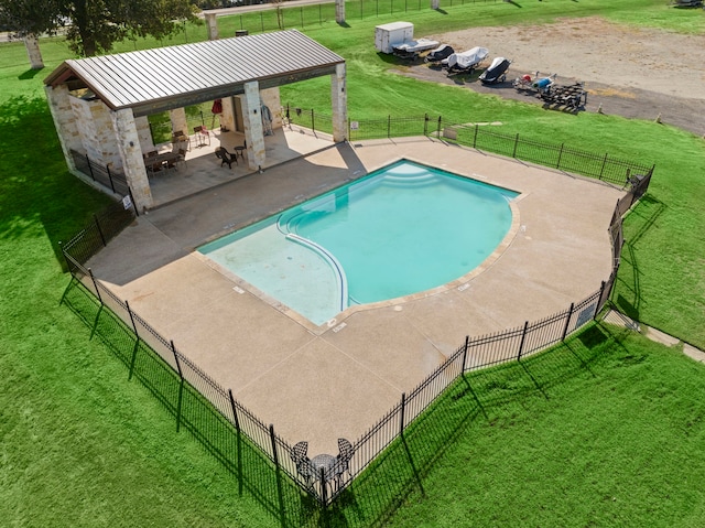 view of swimming pool featuring a patio and a yard