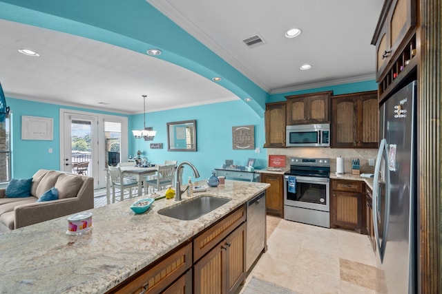 kitchen featuring stainless steel appliances, pendant lighting, sink, tasteful backsplash, and light tile floors