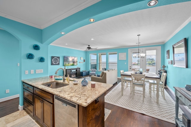 kitchen with hanging light fixtures, dark wood-type flooring, ceiling fan with notable chandelier, sink, and dishwasher