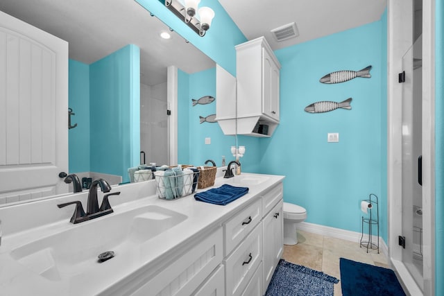 bathroom with an enclosed shower, tile flooring, dual vanity, and toilet