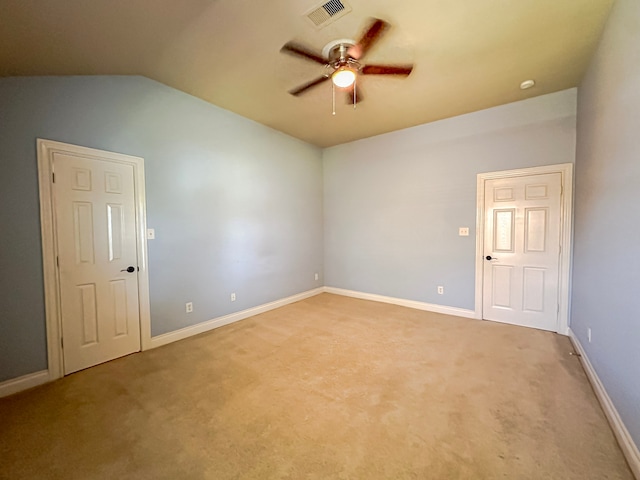 empty room with lofted ceiling, carpet flooring, and ceiling fan