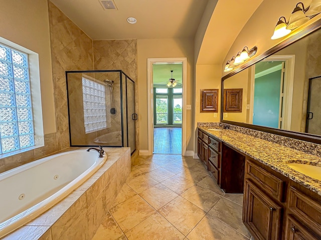 bathroom featuring tile floors, ceiling fan, shower with separate bathtub, and double sink vanity