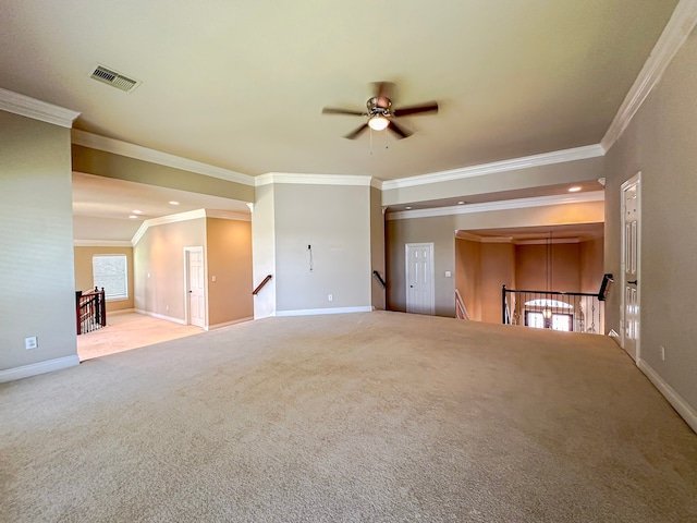 unfurnished living room featuring carpet, ceiling fan, and crown molding