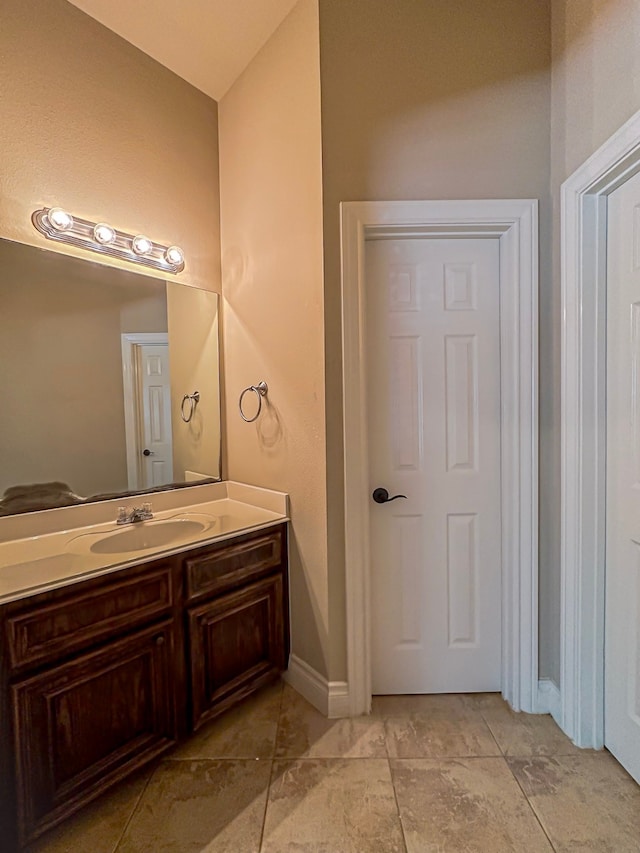 bathroom featuring tile floors and vanity