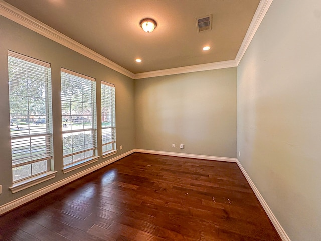 empty room featuring dark hardwood / wood-style flooring and crown molding