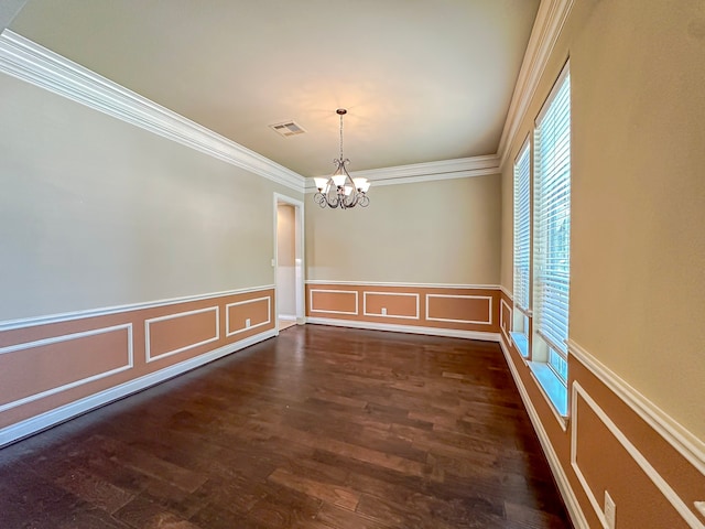 spare room featuring crown molding, an inviting chandelier, and dark hardwood / wood-style flooring