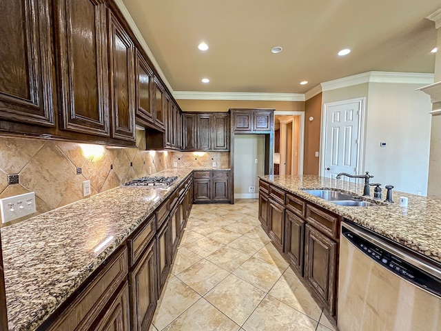 kitchen with crown molding, stainless steel appliances, stone counters, sink, and tasteful backsplash