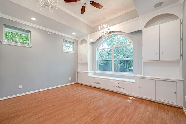 empty room featuring ceiling fan with notable chandelier, ornamental molding, and light hardwood / wood-style floors