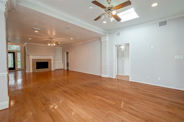 unfurnished living room featuring ceiling fan, crown molding, and light hardwood / wood-style flooring