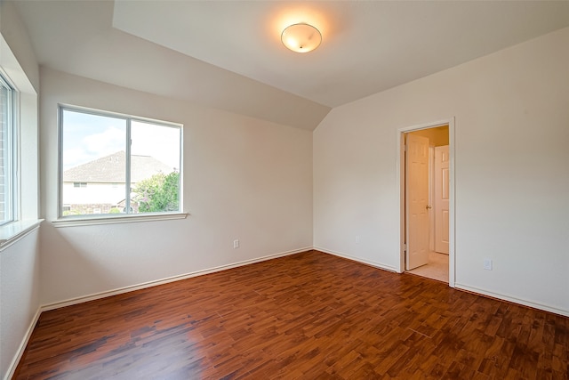 unfurnished room with hardwood / wood-style flooring and vaulted ceiling