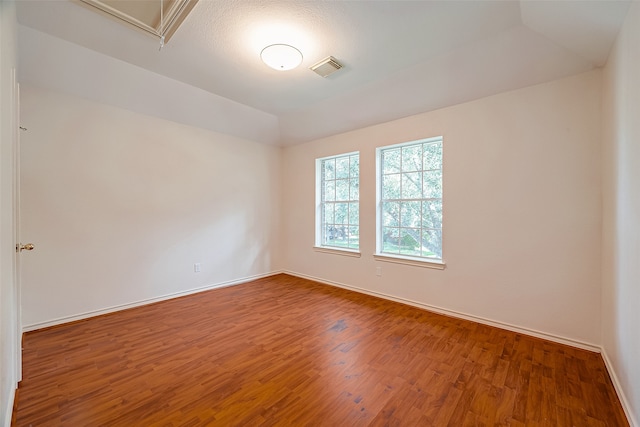 unfurnished room with hardwood / wood-style flooring