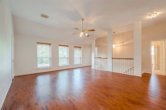 empty room with ceiling fan, vaulted ceiling, and dark hardwood / wood-style floors