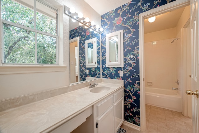 bathroom with bathing tub / shower combination, vanity, and tile patterned floors