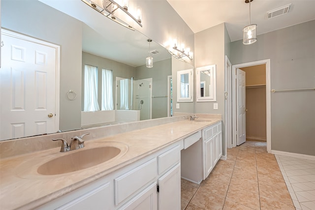 bathroom with tile patterned flooring, a shower, and vanity