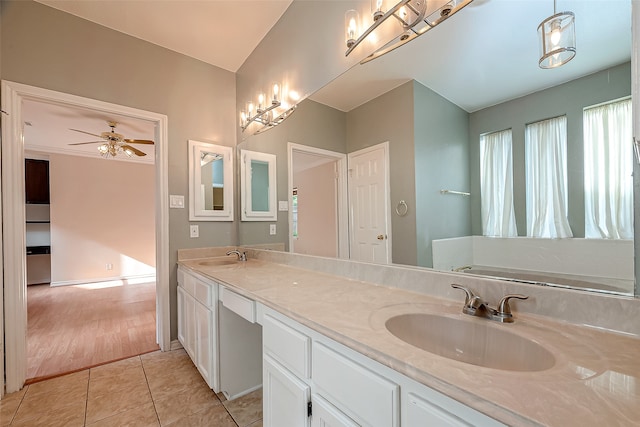 bathroom featuring a washtub, ceiling fan, tile patterned floors, and vanity