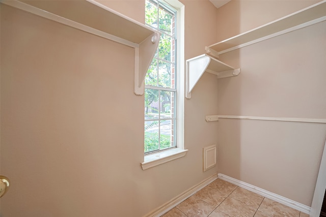 spacious closet with light tile patterned floors