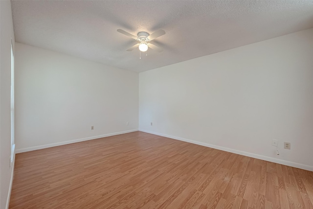 unfurnished room with ceiling fan, light hardwood / wood-style floors, and a textured ceiling