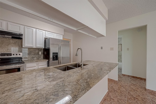 kitchen with light stone countertops, appliances with stainless steel finishes, extractor fan, sink, and white cabinetry