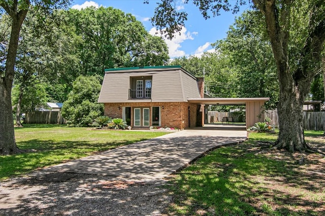 view of front of house with a front lawn and a carport