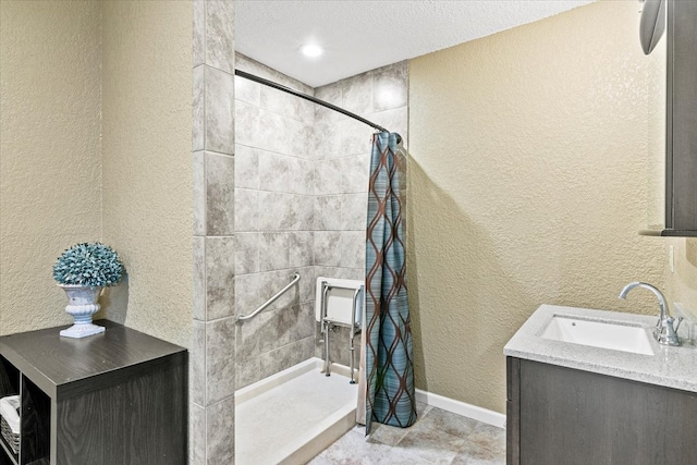 bathroom with tile floors, a shower with shower curtain, a textured ceiling, and vanity