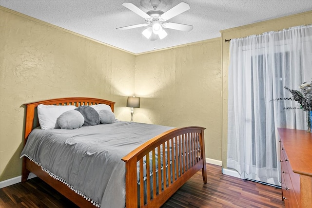 bedroom featuring dark hardwood / wood-style floors, ceiling fan, and a textured ceiling