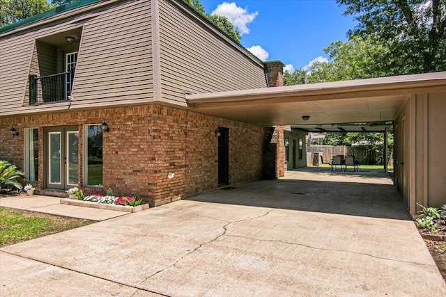 view of home's exterior with a carport and a balcony