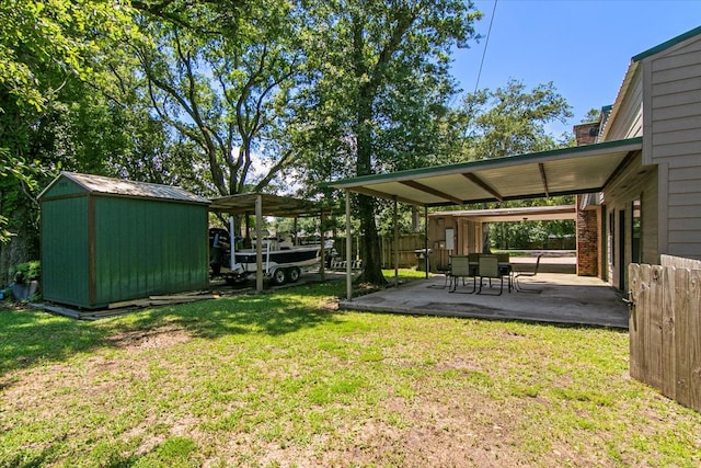 view of yard with a storage unit and a patio area