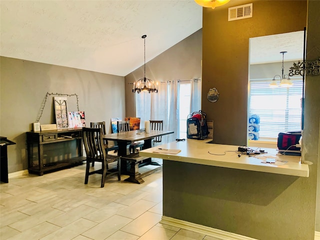 interior space with a wealth of natural light, an inviting chandelier, light tile floors, and lofted ceiling