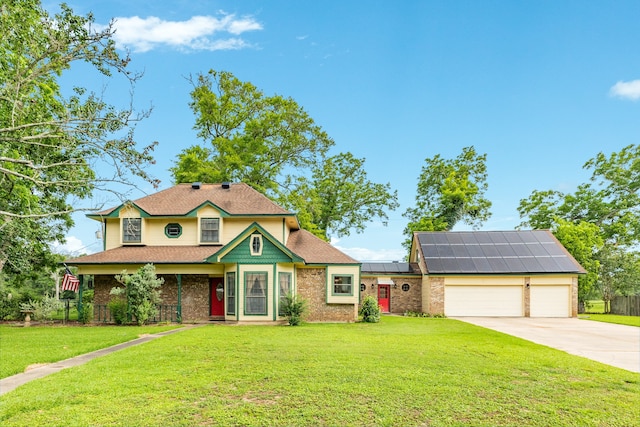 view of front of home featuring a garage, a front lawn, and solar panels