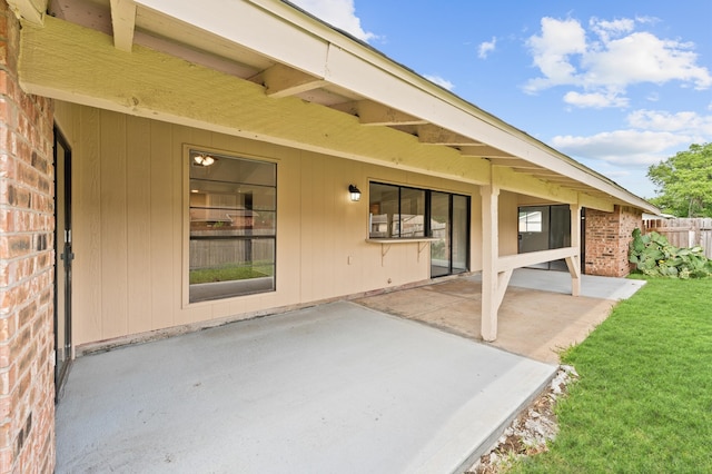 exterior space with a patio and a lawn