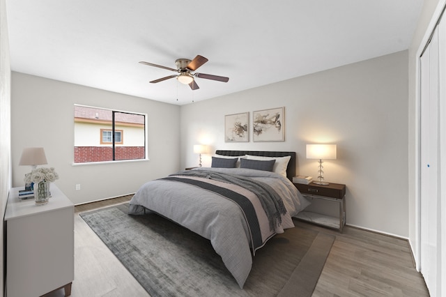 bedroom featuring ceiling fan, a closet, and hardwood / wood-style floors