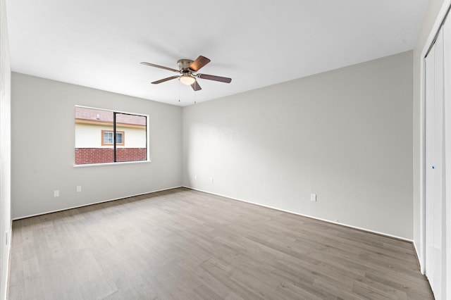 spare room featuring wood-type flooring and ceiling fan