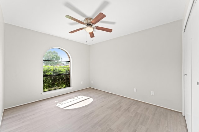 empty room featuring ceiling fan and light hardwood / wood-style floors