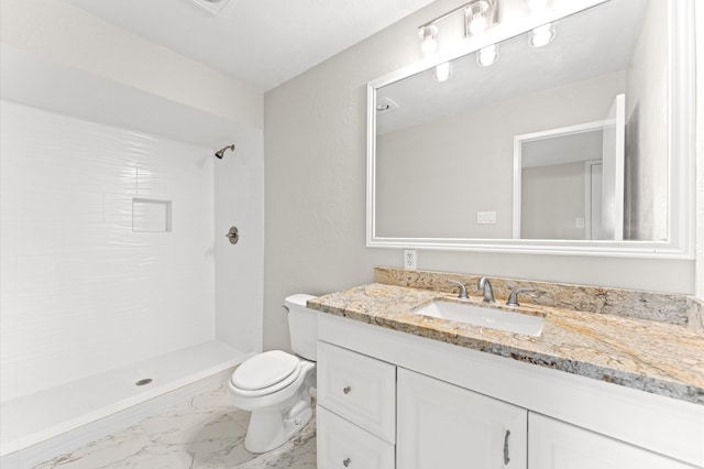 bathroom featuring a tile shower, toilet, tile floors, and large vanity