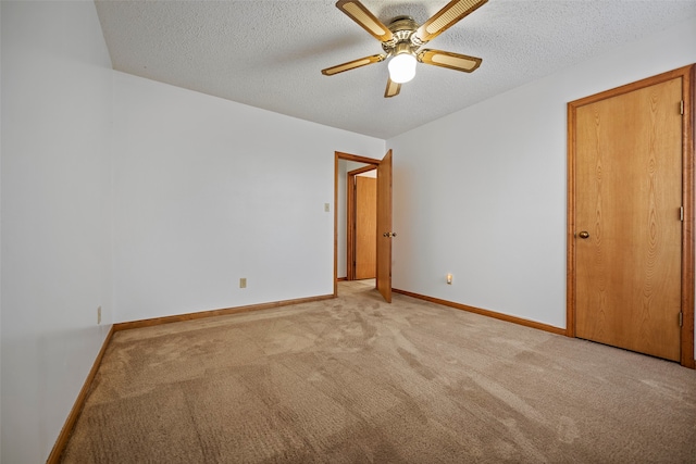 unfurnished bedroom with a textured ceiling, carpet, and ceiling fan